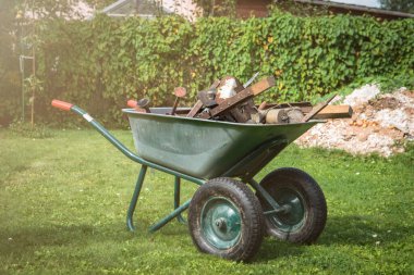 Pile of scrap metal in a barrow. Yard and garden cleaning.