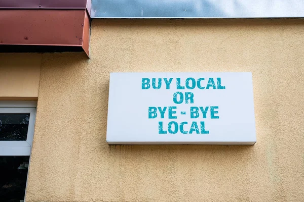 BUY LOCAL OR BYE - BYE LOCAL. White light advertising sign.