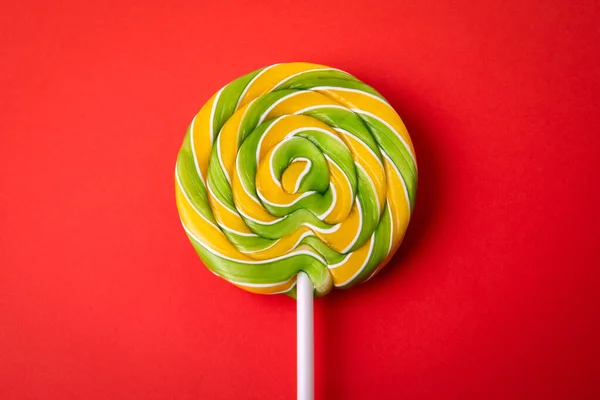 Yellow Green Candy Stick Lollipop Red Background — Stock Photo, Image