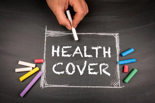 Health Cover. Text and colored pieces of chalk on a blackboard background.
