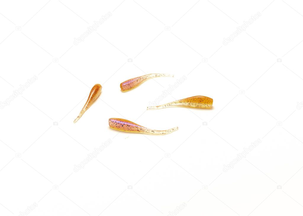 Four soft plastic baits for crappie fishing isolated on white background. Pink color durable minnows fishing tackle gear