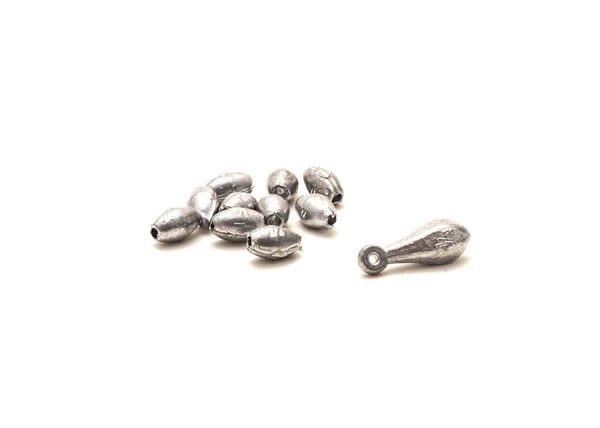 Assortment of silver bank and egg sinkers fishing accessories isolated on white background. Ideal for Carolina rigging allow anglers to get down deep for ground bottom fishing