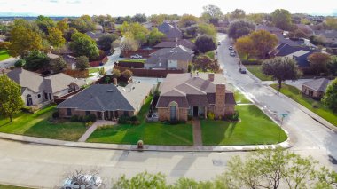 Carrollton, Teksas 'ta geniş arka bahçesi olan parka bakan evler. Dallas 'ın banliyölerinde olgunlaşmış ağaçları ve düşen yaprakları olan tipik bir aile evinin üzerinde.