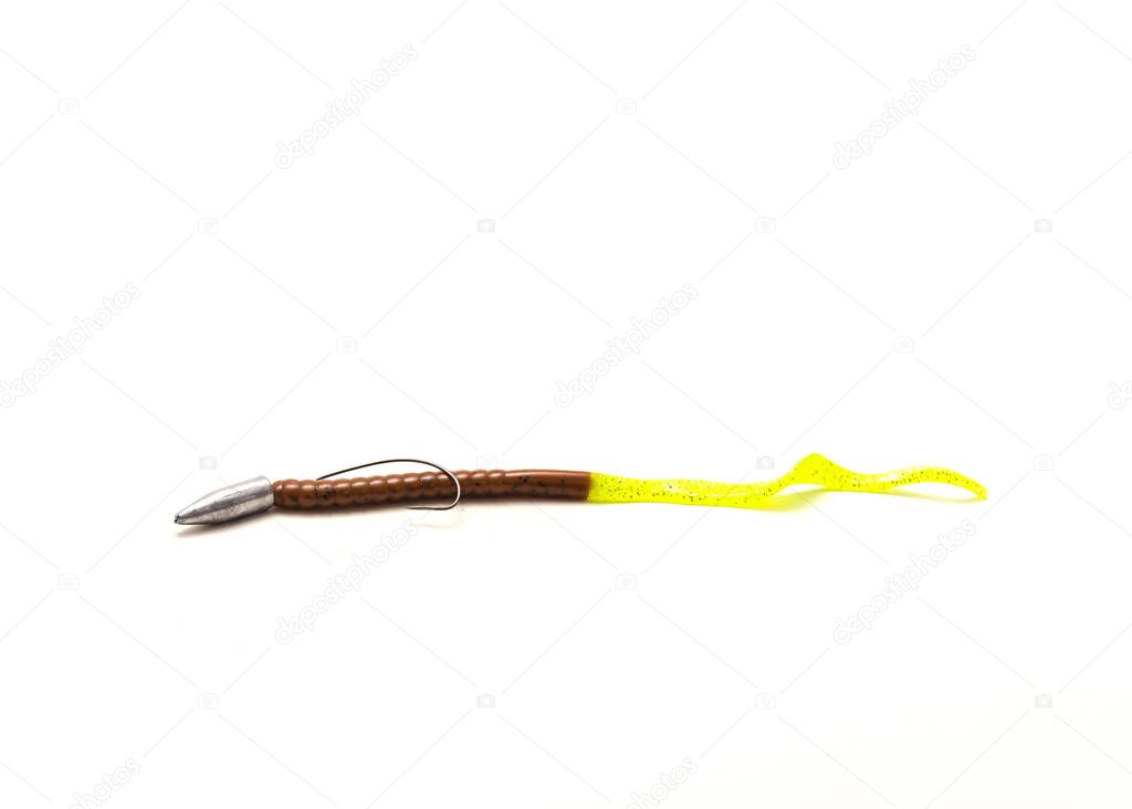 Texas rig fishing terminal tackle with plastic worm, bullet shape sinker and offset worm hook isolated on white background. Glowing green pumpkin lure bait for bass fishing freshwater