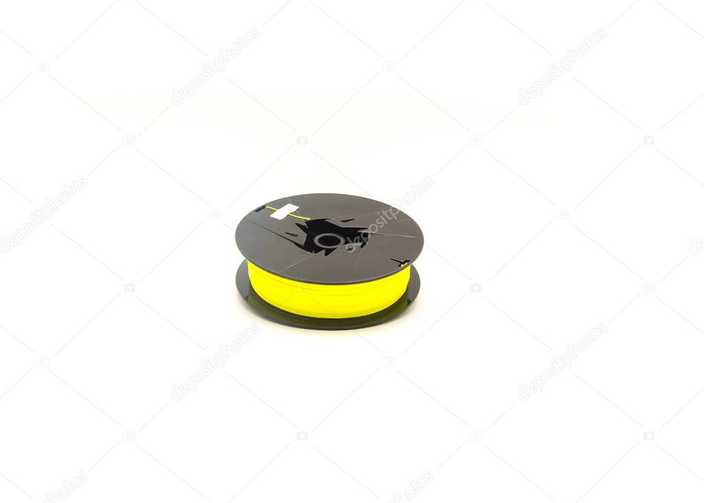 Top view a brand new spool of yellow braided fishing line isolated on white background. Polyethylene braid fiber with small diameter