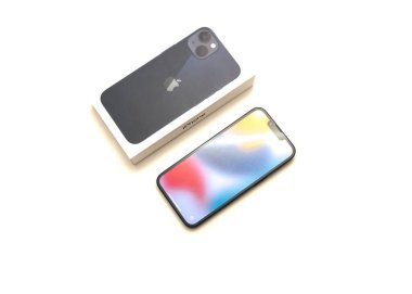 COPPELL, TX, USA-JAN 4, 2022: Üst görünüm kutusu ve Apple iPhone 13 'ün yepyeni hoş geldin ekranı beyaz arka planda izole edilmiş yeni gece yarısı rengi