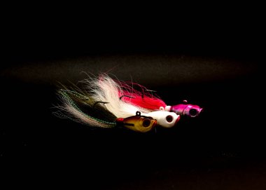 Three bucktail Jig heads lure hand tie deer hair fishing jig hooks isolated on black background. clipart