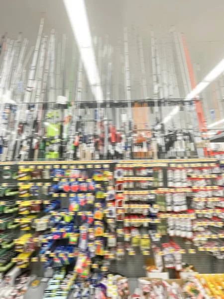 Blurry full of fishing terminal tackles and upright standing pole, rod and reel combos at department store near Dallas, Texas, USA — Stock Photo, Image