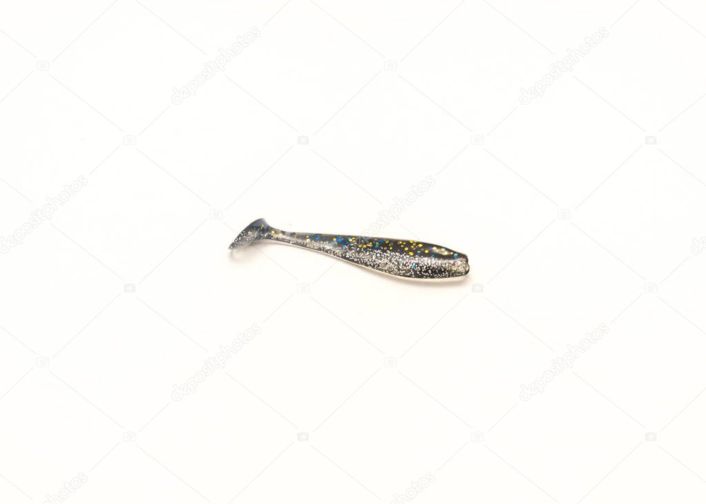 Single Plastic Worms Baits Paddle Tail Swim bait with Chartreuse Glitter isolated on white background. Shad fishing lure swim bait with clipping path and copy space.