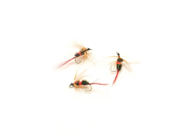 Three fly fishing lures in different files, colors and hook sizes isolated on white background. Assortment of dry, wet hand-tied light weight flies with sharp carbon steel hooks