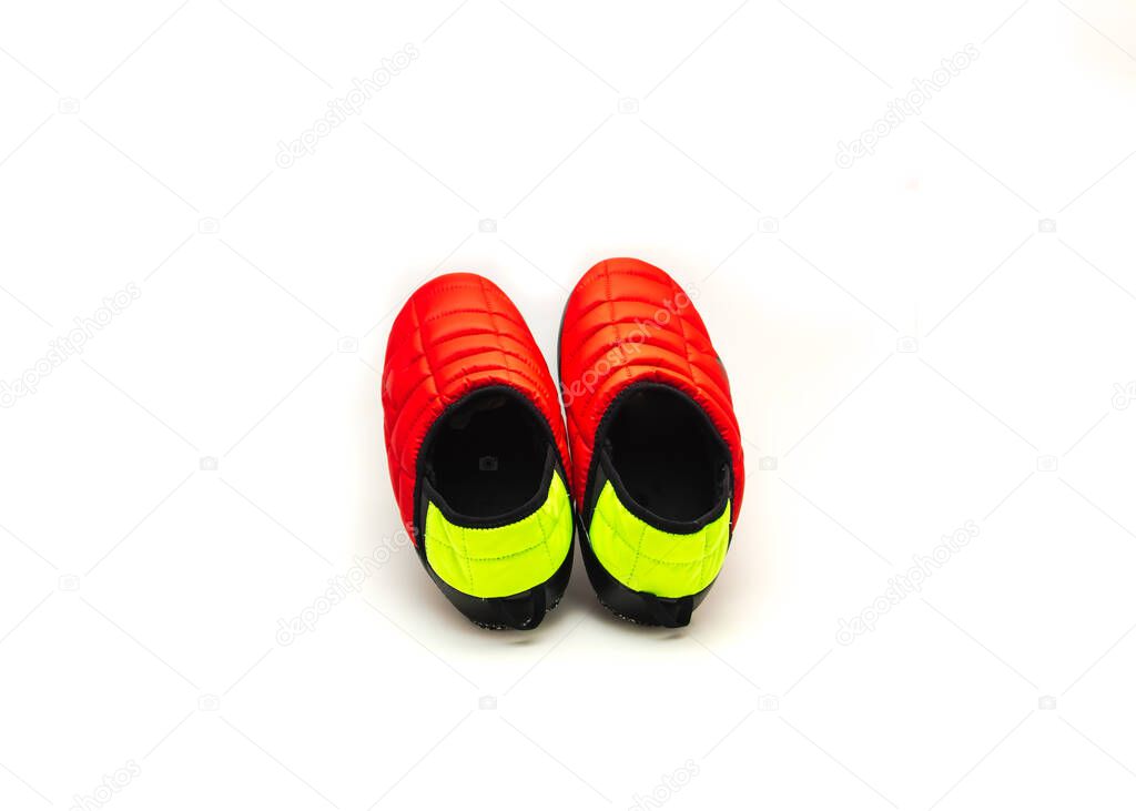 A pair of brand new red black green slip-on shoes mules isolated on white background. Ripstop upper, collapsible heel warmth and comfort sneaker footgear.
