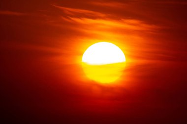 Gün batımında ya da şafakta parlak kırmızı bir güneş