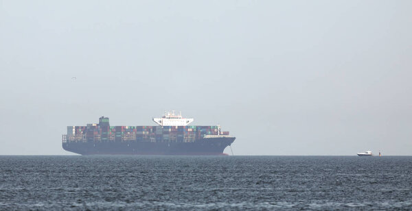 Large container ship on a background of sky and haze.