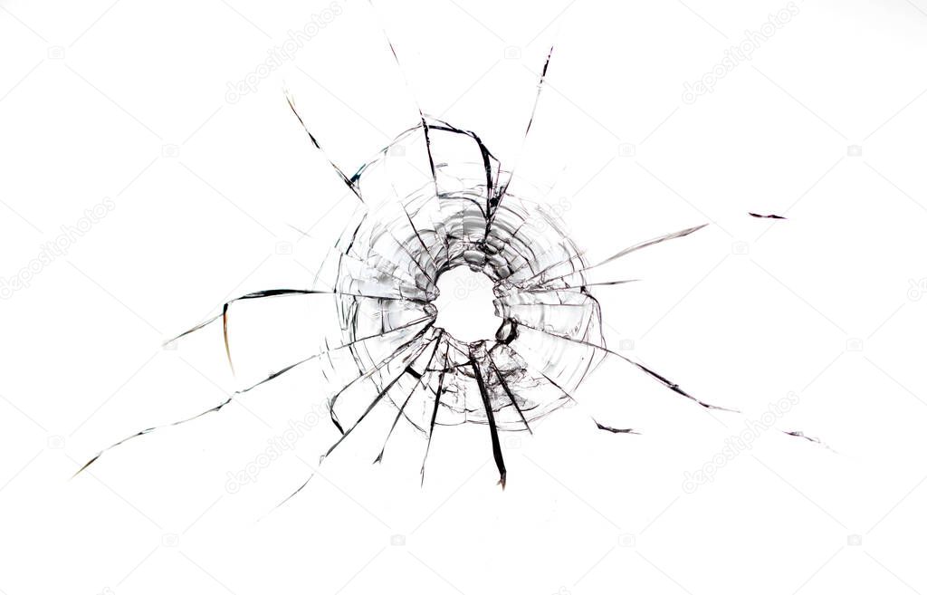 Cracks in the glass from the bullet. Abstract background. Damaged glass. Cracks on a white background.
