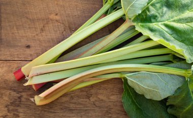 Taze taze rubarb yaprakları eski ahşap bir masada. Üst Manzara. Vejetaryen yemeği. İlaç fabrikası kardiyovasküler sistem için faydalıdır..