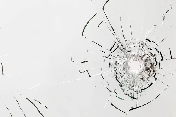 Bullet hole in the rock. Broken window, cracks. Abstract background or texture