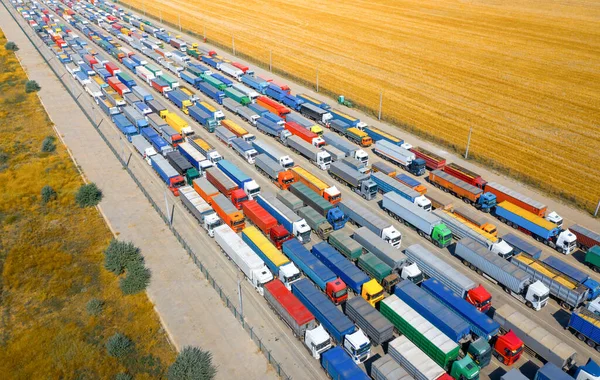 A huge queue of trucks loaded with grain crops in a blocked Ukrainian port. Humanitarian crisis due to the war.