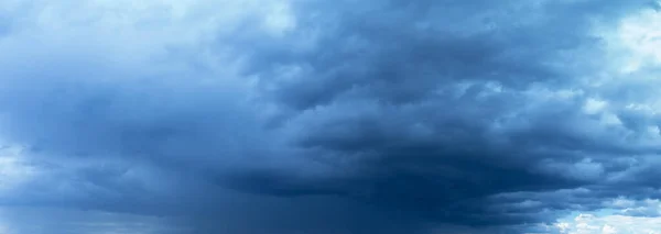 Stormy sky before rain. Abstract natural background. Heavy dark rain clouds on a light sky background.