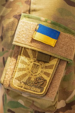 August 12, 2022 Ukraine Orativ: Chevron of the Armed Forces of Ukraine on camouflage uniforms. Close-up, selective focus.