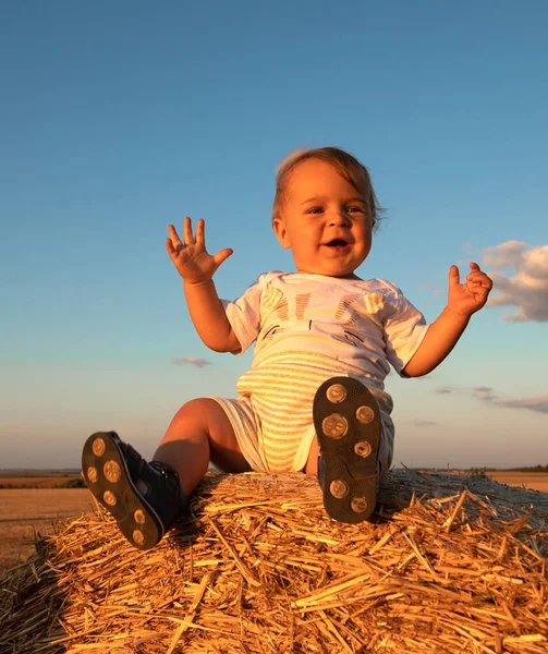 Cheerful Little Boy Sitting Large Bale Straw Rest Countryside — Stock Fotó
