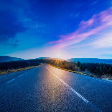 A wonderful seascape. High-quality asphalt road in the mountains before dawn.