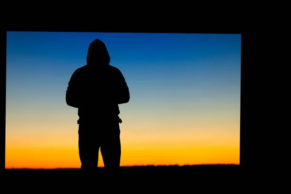 Silhouette of a person on the background of the blue sky. Abstract natural background.