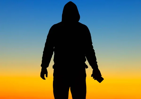 Silhouette of a person on the background of the blue sky. Abstract natural background.