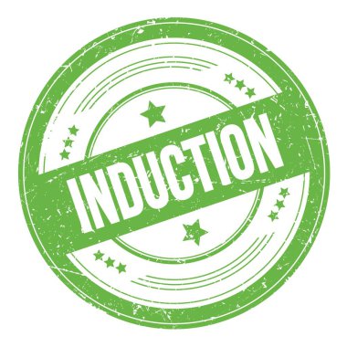 Yeşil yuvarlak, kirli doku damgası üzerine INDUCTION metni.