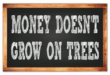 MONEY DOESN'T GROW ON TREES written on black wooden frame school blackboard