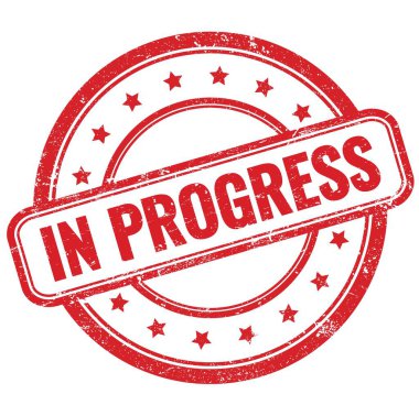 IN PROGRESS text on red vintage grungy round rubber stamp.