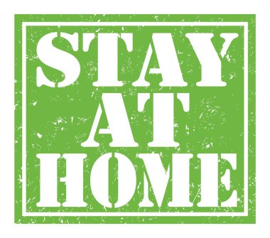 STAY AT HOME, words written on green stamp sign