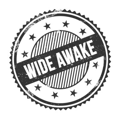 Siyah grungy zig zag kenarlarında yazılmış WIDE AWAKE metni yuvarlak pul.