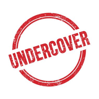 UNDERCOVER kırmızı grungy vintage yuvarlak pul üzerine yazılmış metin.