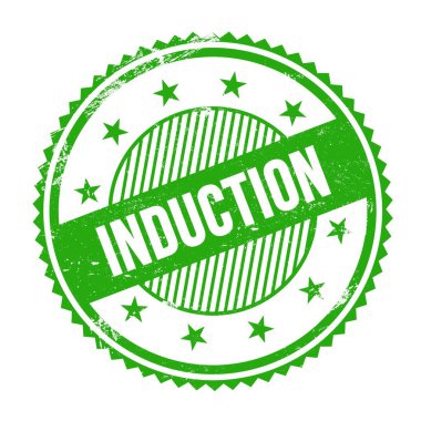Yeşil grungy zig zag kenarları üzerine yazılmış INDUCTION metni yuvarlak pul.