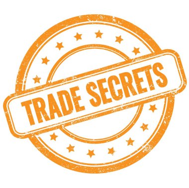 TRADE SECRETS text on orange vintage grungy round rubber stamp.