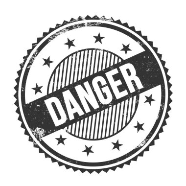 Siyah grungy zig zag kenarları üzerine yazılmış DANGER metni yuvarlak pul.