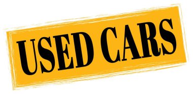 USED CARS text written on orange-black rectangle stamp sign.