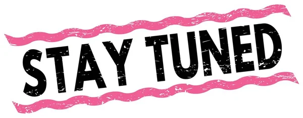 STAY TUNED text written on pink-black lines stamp sign.