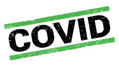 COVID text written on green rectangle stamp sign.