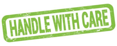 HANDLE WITH CARE text written on green rectangle stamp sign.