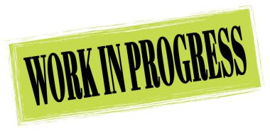 WORK IN PROGRESS text written on green-black rectangle stamp sign.