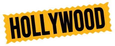 HOLLYWOOD text written on orange-black zig-zag stamp sign.