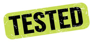 TESTED text written on green-black grungy stamp sign.