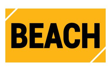 BEACH text written on yellow-black rectangle stamp sign.