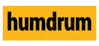 humdrum text written on yellow-black grungy stamp sign.