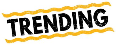 TRENDING text written on yellow-black lines stamp sign.