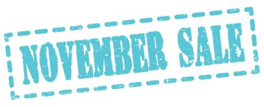 Mavi pano işareti üzerine yazılmış Kasım Satışı metni.