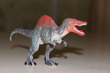 Arka planda Spinosaurus oyuncak dinozoru
