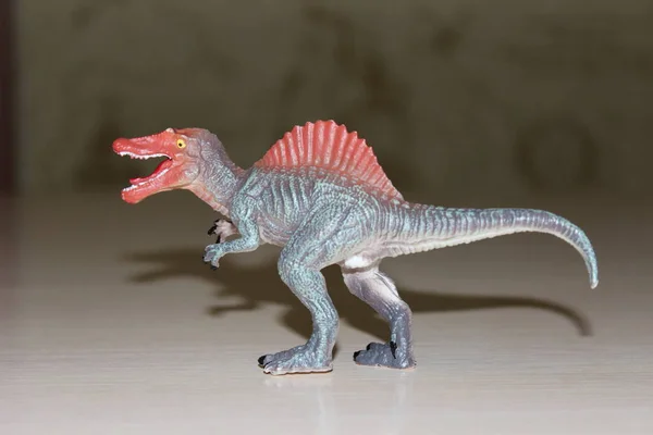 Spinosaurus toy dinosaur on background