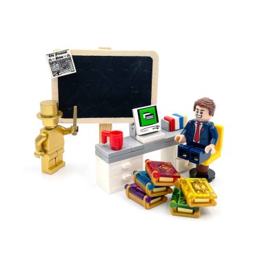 A businessman learn business strategy from success golden man. Lego figure photography concept idea.